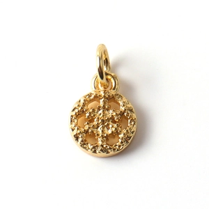 Detailed close-up of a gold-plated snowflake pendant with intricate hollowed-out engraving