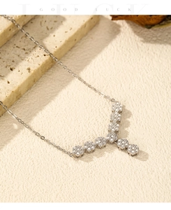 Macro detail of S925 sterling silver Y-shaped flower necklace with sparkling cubic zirconia