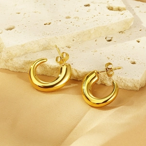 Elegant 18K gold plated stainless steel C-shape earrings on neutral textured stone