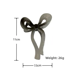 Detail view showing 11cm gray acrylic bow hair claw clip dimensions and 26g weight