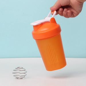 Detail view of orange sports shaker bottle with mixing ball and sturdy carry handle