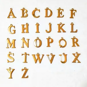 Detailed set of 26 golden alphabet charms for DIY jewelry making on white background