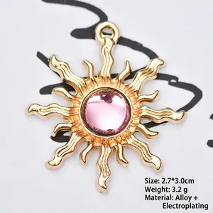 Close-up of golden sunflower charm with pink gemstone inlay, size 2.7x3.0cm, for DIY jewelry