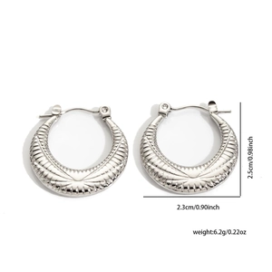 Detail view of silver crescent earrings with radial texture and precise dimensions