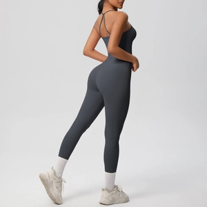 Detail of charcoal grey yoga jumpsuit showing strappy open back and slimming fit