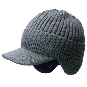 Close-up of thick ribbed knit texture and ear protection flaps on a dark grey winter beanie