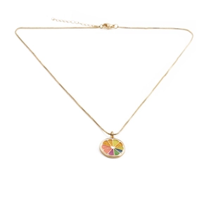 Detailed close-up of a colorful citrus slice pendant on a gold-plated necklace chain