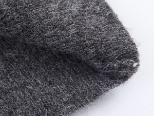 Detailed macro view of soft charcoal grey knitted fabric texture and plush fiber material