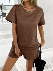Close-up of coffee brown knit two-piece set with diamond geometric texture and short sleeves