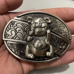 Detailed relief of an ornate pig belt buckle with traditional Chinese folk patterns