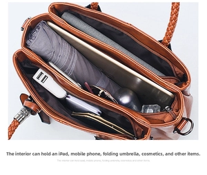 Spacious interior of brown Boston bag showing compartments for iPad, phone, and umbrella