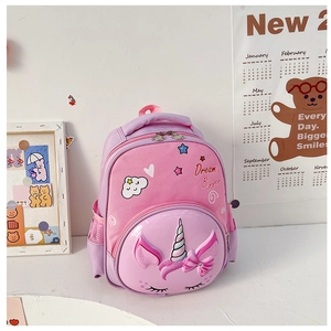 Detail of pink unicorn kids backpack featuring a 3D horn and Dream Bigger embroidery