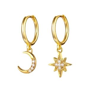 Macro detail of asymmetric gold crescent moon and North Star earrings with white zircon