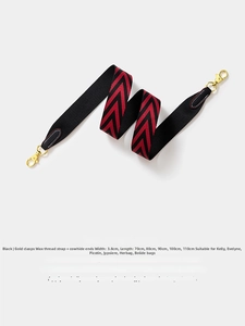 Macro detail of 3.8cm wide V-pattern strap with black leather ends and gold metal hardware