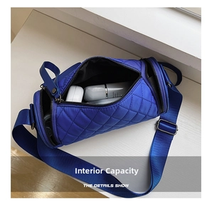 Interior storage capacity of the quilted blue cylinder crossbody bag showing cosmetics