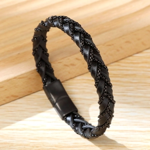 Detail of hand-woven black microfiber leather bracelet with a black magnetic stainless steel clasp