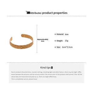 Detail showing the hammered texture and size parameters of the gold open cuff bracelet