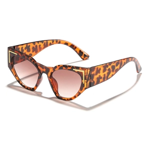 Cat eye tortoiseshell sunglasses with brown gradient lenses and gold metal accents