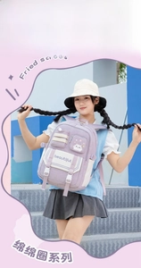 Detail of purple and white school backpack with functional zippers and cat patch