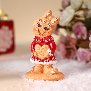Gingerbread girl figurine with red dress and yellow heart for Christmas home decor