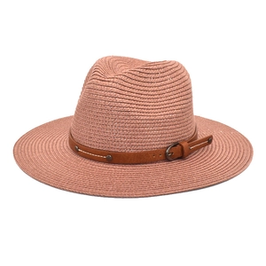 Detail of breathable straw Panama hat with brown leather belt and metallic buckle