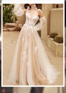 Detail of ivory bridal dress featuring floral lace embroidery and soft tulle layered skirt