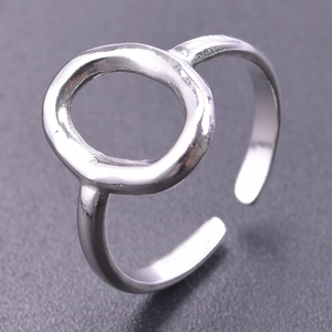 Macro shot of silver open ring with minimalist oval geometric cutout design