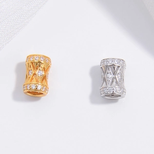 Macro detail of S925 silver spacer beads with zircon inlays and hollowed rhombus patterns