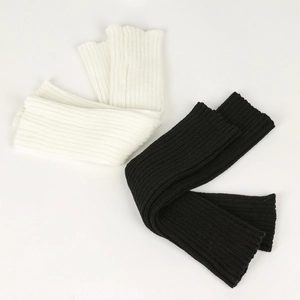 Detailed ribbed texture of black and white knitted leg warmers for girls
