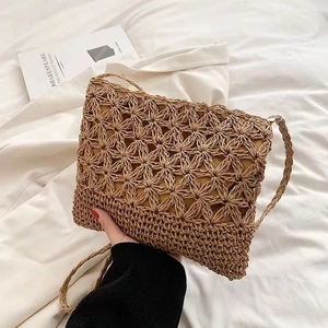 Crossbody straw woven bag with hollow star flower pattern for summer beach vacations
