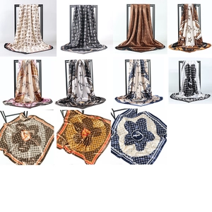 Detailed close-up showing various patterns and glossy satin textures of square scarves