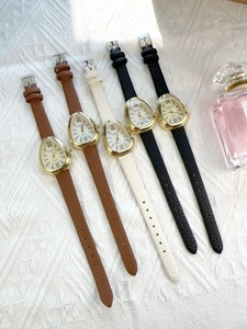 Detail view of five assorted leather strap watches with unique drop-shaped gold cases