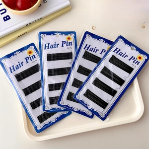 Classic black metal bobby pins with ball tips in four packs for secure hair styling