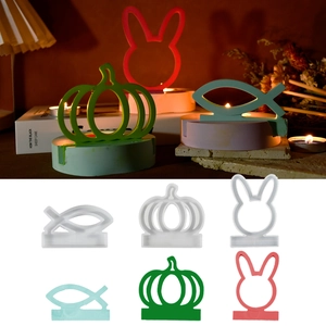Detail showing pumpkin and rabbit silicone molds with finished resin candle holders
