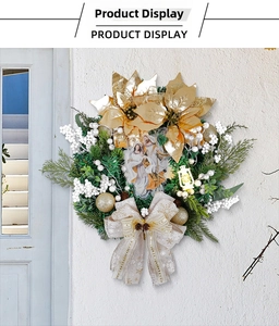 Close-up of golden Christmas wreath featuring Holy Family motif and glowing lantern