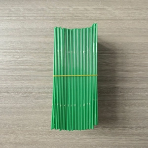 Close-up of green plastic Christmas ornament hooks bundled with a yellow rubber band