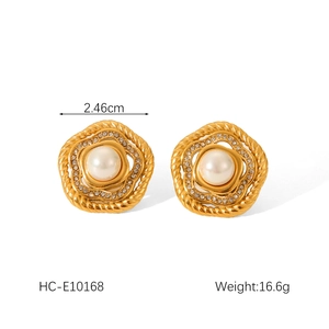 Detail of 18k gold flower earrings featuring white pearls and diamond accents