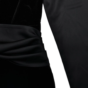Detail showing the elegant contrast between black velvet fabric and satin pleated waist