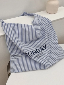 Blue and white striped canvas tote bag with Sunday text on a minimalist display