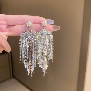 Close-up of Bohemian long tassel earrings with sparkling rhinestones and pearls