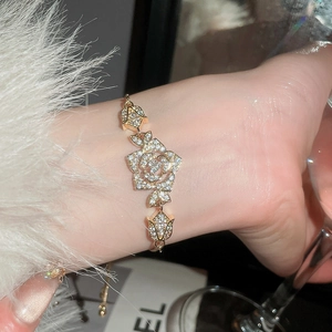Detail shot of sparkling zircon flower bracelet with hollow rose and tulip charms