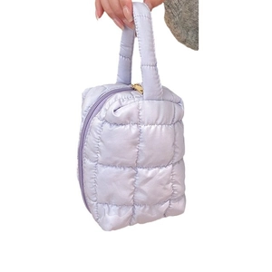 Lavender quilted tote makeup bag with gold zipper and top handle on white background