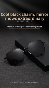 Close-up of polarized black square sunglasses leaning on premium matte box with dramatic lighting