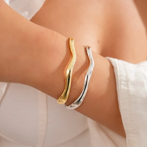 Minimalist 18k gold and silver plated wavy geometric bangles for women on wrist