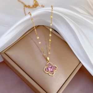 Titanium steel flower necklace with pink gemstones and crystal accents on a jewelry box