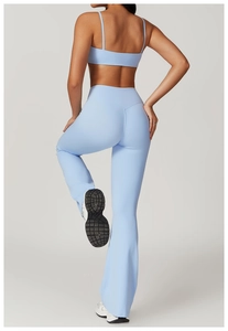 Detail of light blue cross-back sports bra and flared yoga leggings for women