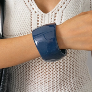 Detailed close-up of navy blue resin wide cuff bracelet with high gloss mirror finish