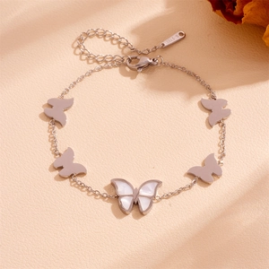 Detail of silver stainless steel butterfly bracelet with white shell inlay and lobster clasp