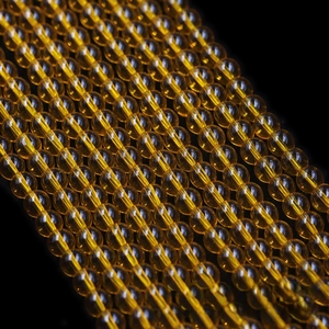 Macro shot of polished amber round glass beads for DIY jewelry making