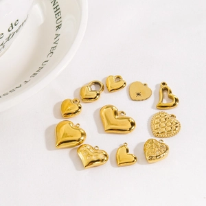Various golden stainless steel heart charms with different textures and patterns